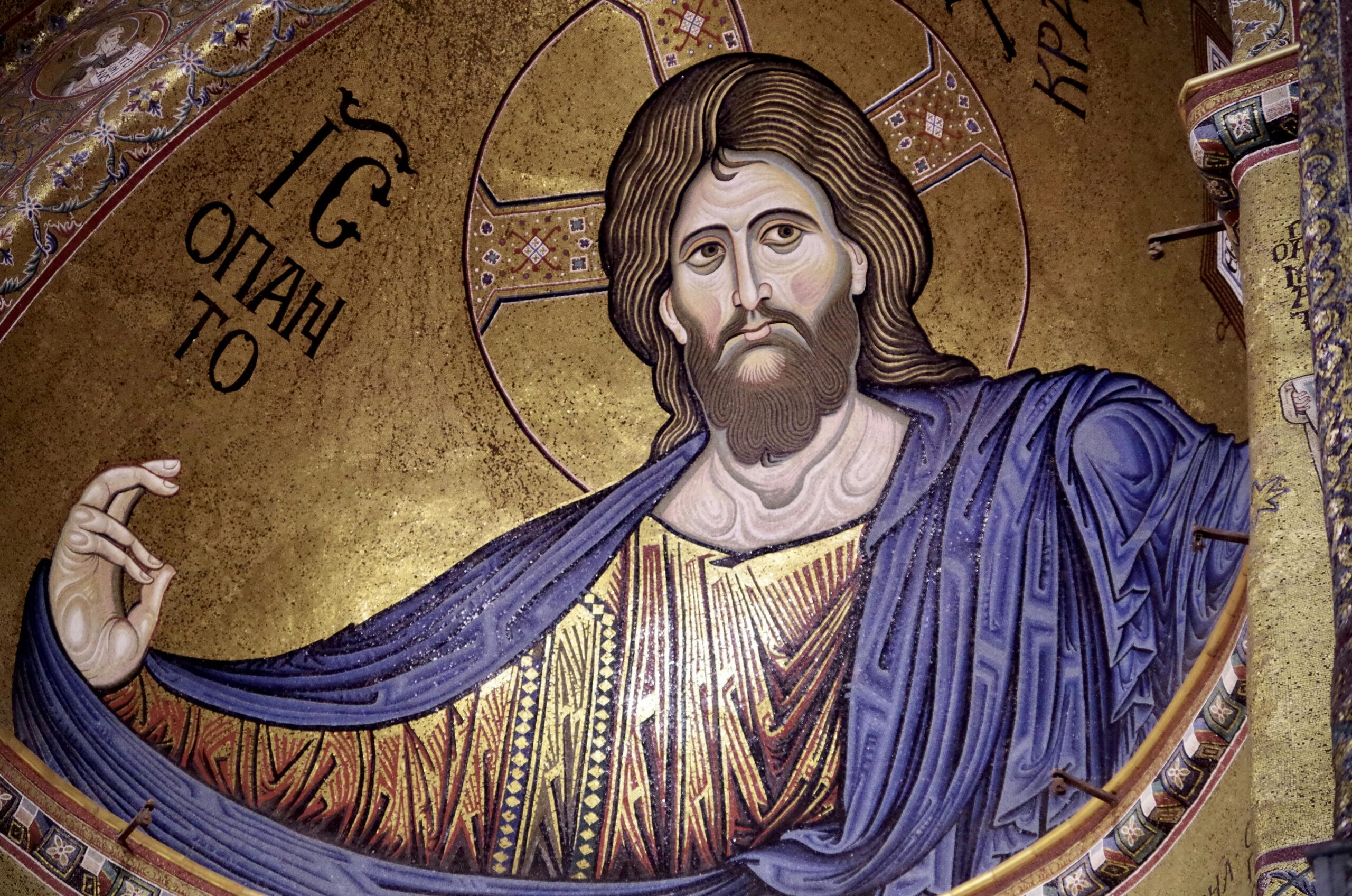 Close-up of a Jesus Christ mosaic in the Monreale Cathedral, showcasing religious art in Sicily.
